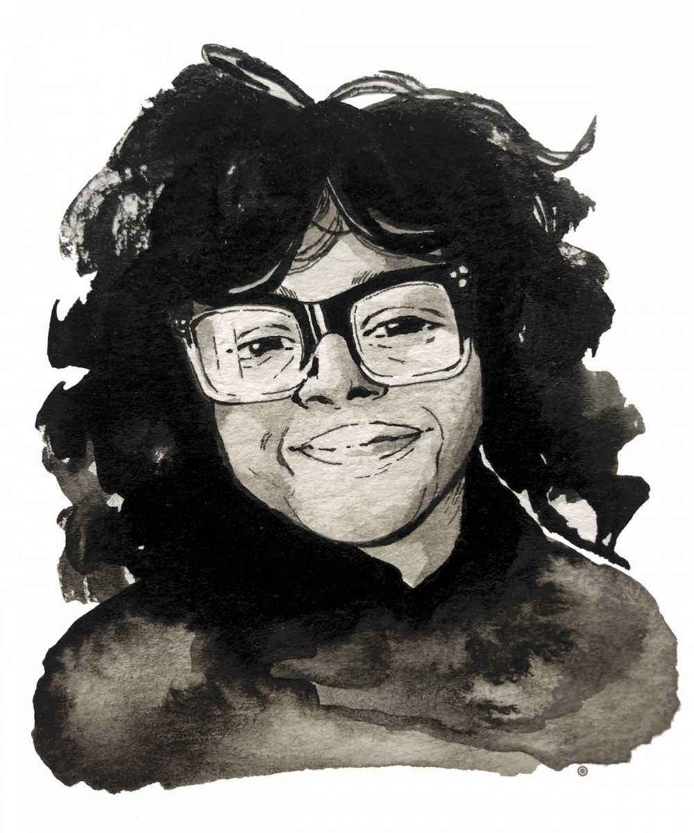 A pen-and-watercolour portrait of Tracey Thompson. Tracey has big, curly black hair with bangs, brown skin, and large square-framed glasses. She is tilting her head and smiling slightly at the viewer.