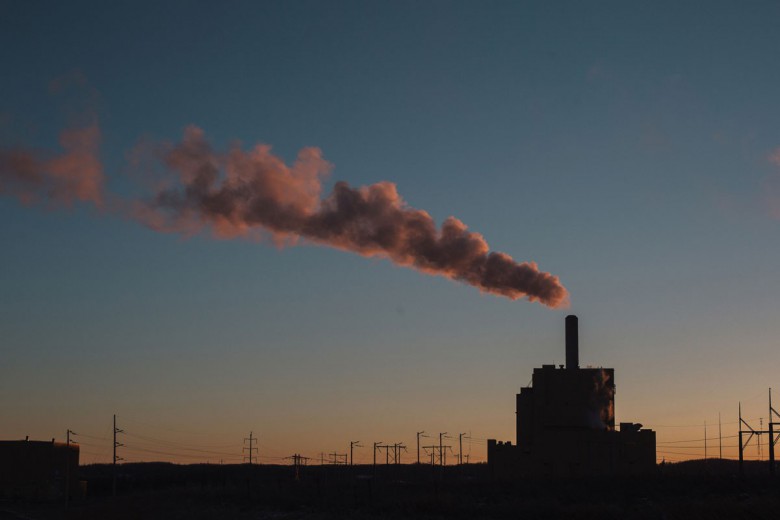 A plume of smoke billows out of the coal fired Keephills Power Station in Wabamun, Alberta at sunset.